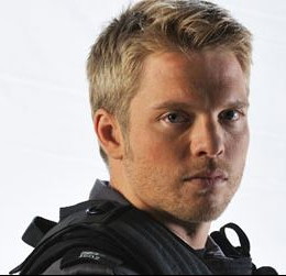 Headshot of David Paetkau in black paratrooper clothing