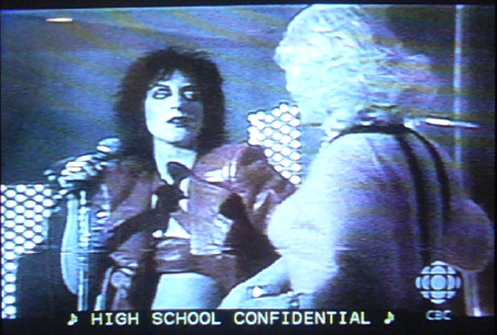 Carole Pope and bewigged transvestive: â™ª HIGH SCHOOL CONFIDENTIAL â™ª